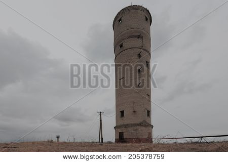 Old abandoned brick water tower. horizontal shot on a cloudy day