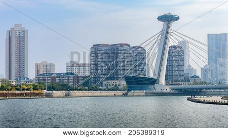 Tianjin, China - Nov 1, 2016: Chingfen Bridge spans across the Haihe River. Backgropund buildings in contrasting modern and old architectural style. Viewed from Tianjin Railway Station.