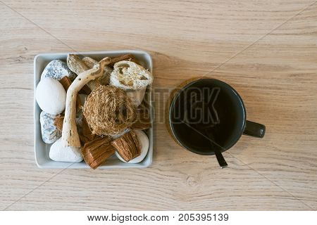 filament of zucchini Coconut spathe fiber rattan ball stone on Square plate with cup.