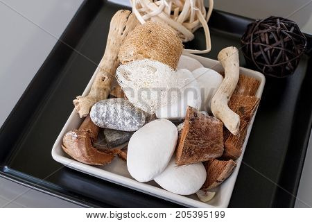 filament of zucchini Coconut spathe fiber rattan ball stone on Square plate.