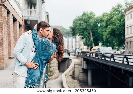 Guy and girl on a city street posing on camera