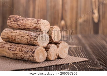 Close up Thanaka wood on wooden plank background