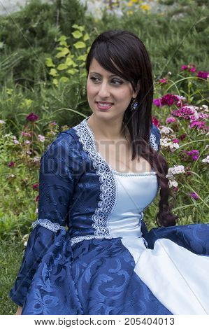 CAGLIARI, ITALY - JUNE 1, 2014: Sunday at the Great Jatte Public Gardens - portrait of a beautiful woman wearing a Victorian style costume - Sardinia