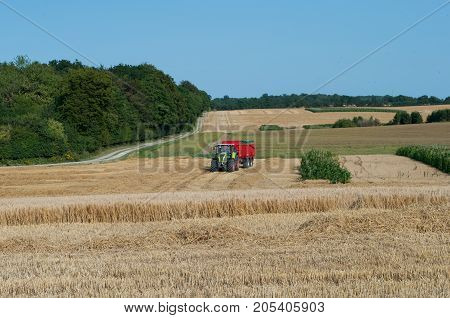 Tractor Waiting For A Harvester On  Field