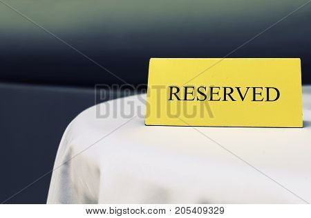 Reserved sign on the table in restaurant Close up