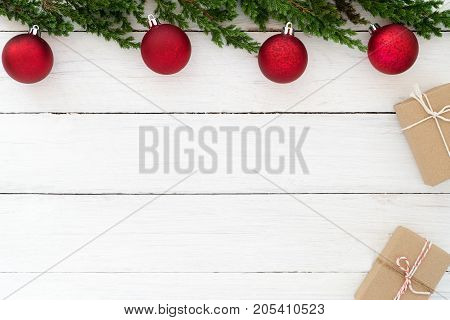 Christmas theme Background. Christmas present gifts box and fir leaves with decoration rustic elements on white wooden. Creative flat lay top view design