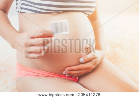 Pregnant Girl In The Hands Holding The Candles Medication