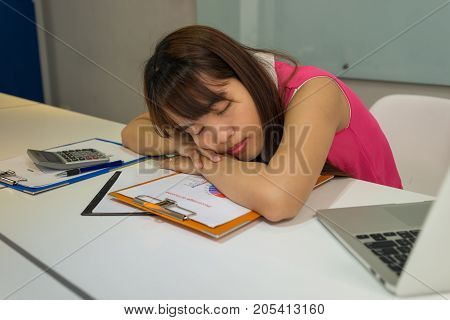 Hardworking office employee sleeping in her office