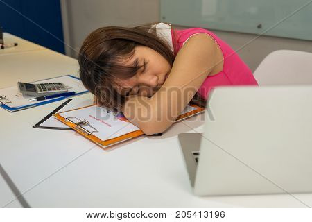 Asian office woman take a nap in office room