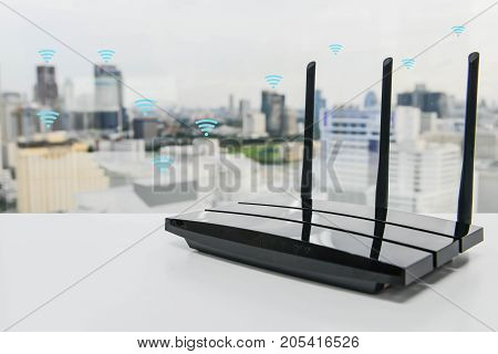 Black three poles wifi router on the white table