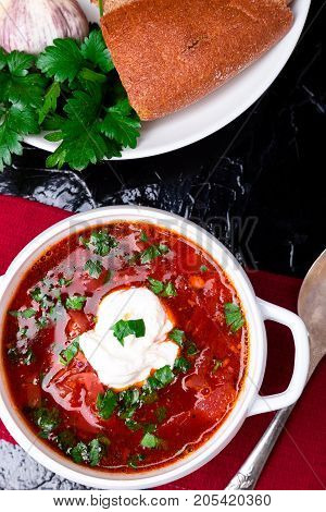 Ukrainian Traditional Borsch. Russian Vegetarian Red Soup  In White Bowl On Red Wooden Background. T