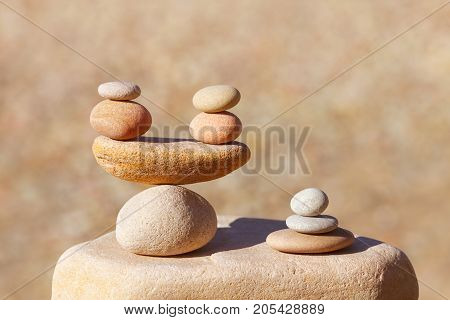 Symbolic scales of stones on blurred background. Concept of harmony and balance. Pros and cons concept. Soft focus selective focus