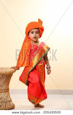 cute indian child in traditional style , posing