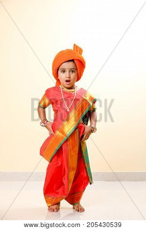 cute indian child in traditional style , posing