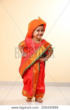 cute indian child in traditional style , posing