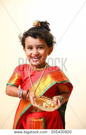 cute indian child in traditional style , posing
