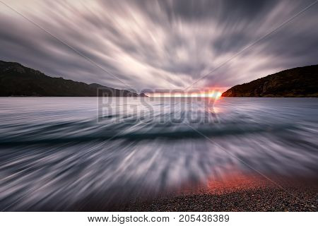 Sunset Under Storm Clouds At Bussaglia Beach In Corsica