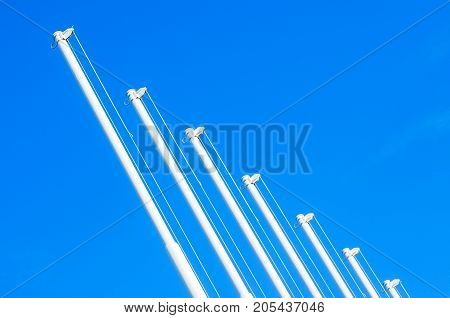 Flagpole with no flag on blue sky background
