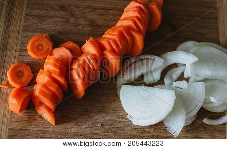 Close Up On Carot And Onion On Wooden Background