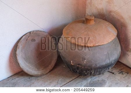 Very Old Hand-Thrown Pottery in an Outdoor Kitchen in Ecuador. Unglazed clay used for cooking in a wood-fired oven
