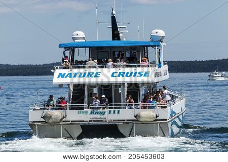 Bar Harbor Maine USA - 28 July 2017: The Bay King III catamaran of the Bar Harbor Whale Watch Company leaving the docks with passengers on a nature cruise tour.