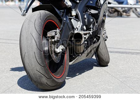 Exhaust Pipe, Rear Brake And Wheel Of Motorcicle.
