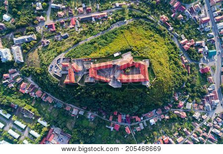 Aerial view of the Majestic Fortress - Palanok Castle towering above the city of Mukacheve, Ukraine. Top view, from above
