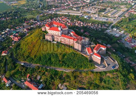 Aerial view of the Majestic Fortress - Palanok Castle towering above the city of Mukacheve, Ukraine.