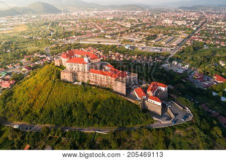 Aerial view of the Majestic Fortress - Palanok Castle towering above the city of Mukacheve, Ukraine.