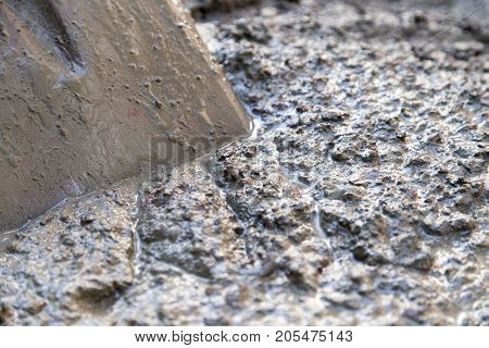 cement solution with a shovel . Photo of an abstract texture