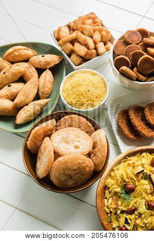 stock photo of  Diwali food or Diwali snacks or Diwali sweets like anarsa, bakarvadi, chakli, sev, bhujiya, shankar pale and chivda or chiwada, karanji, favourite indian diwali recipe, selective focus