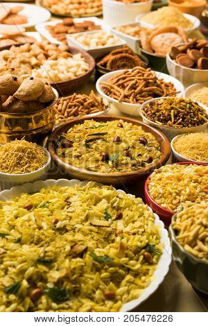 stock photo of  Diwali food or Diwali snacks or Diwali sweets like anarsa, bakarvadi, chakli, sev, bhujiya, shankar pale and chivda or chiwada, karanji, favourite indian diwali recipe, selective focus