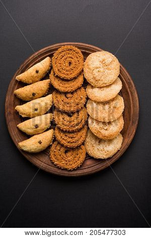 stock photo of Indian festival or diwali food called chakli, anarsa and karanji or Gujiya, selective focus