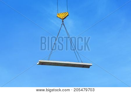 Concrete slab hanging on the cables of the crane hook