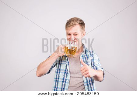Man drinking beer. Happy young man holding a beer mug.