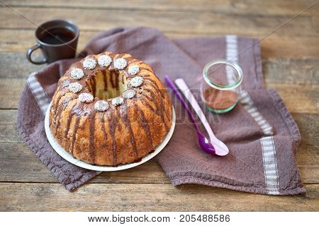 Bundt Cake with Chocolate Fudge Glaze and Chocolate dots circle candy nonpareils with colorful sprinkles on top 
