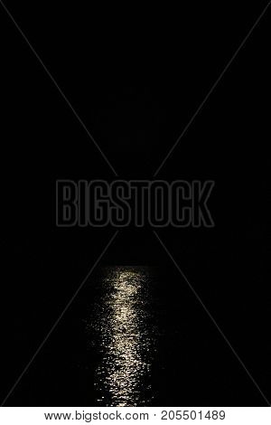 The light from the moon above the water but without the moon itself