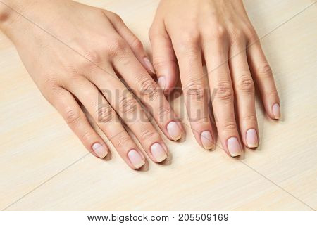 Female gentle hands. Woman beautiful hands on salon table. Woman hands in nails and spa salon.