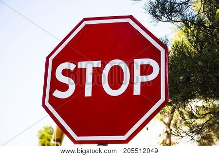Road sign STOP red under the blue sky
