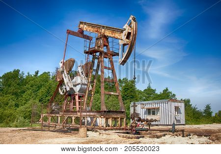 an oil pump is on a background mountains