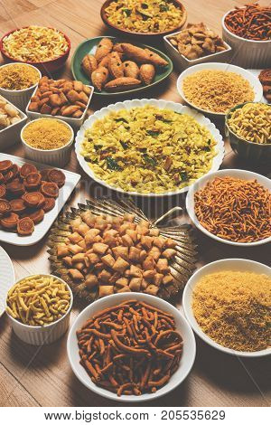 stock photo of  Diwali food or Diwali snacks or Diwali sweets like anarsa, bakarvadi, chakli, sev, bhujiya, shankar pale and chivda or chiwada, karanji, favourite indian diwali recipe, selective focus