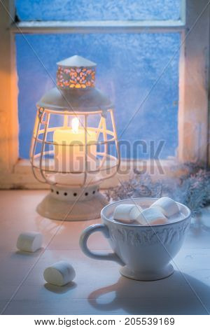 Christmas Chocolate With Marshmallows In Cold Evening By Blue Window
