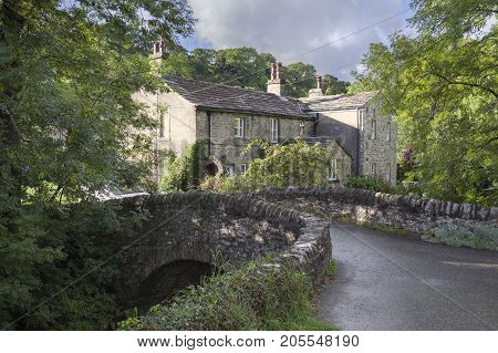 Stone cottage and bridge Kettlewell Yorkshire Dales National Park England.