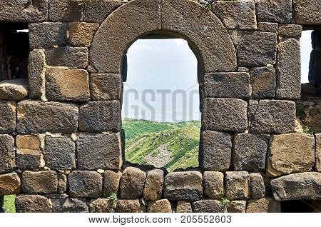 View through the window in brick wall of the medieval armenian fortress Amberd