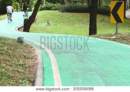 People cycling on bike lanes in Wachirabenchathat Park or State Railway Public Park