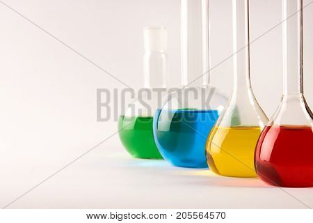 Test Tubes And Flasks With Colorful Liquids Isolated On White
