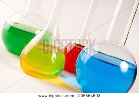Test Tubes And Flasks With Colorful Liquids Isolated On White