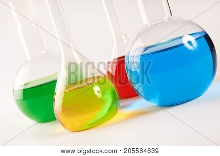 Test Tubes And Flasks With Colorful Liquids Isolated On White