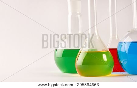 Test Tubes And Flasks With Colorful Liquids Isolated On White