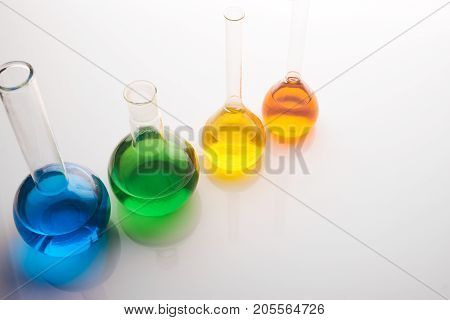 Test Tubes And Flasks With Colorful Liquids Isolated On White